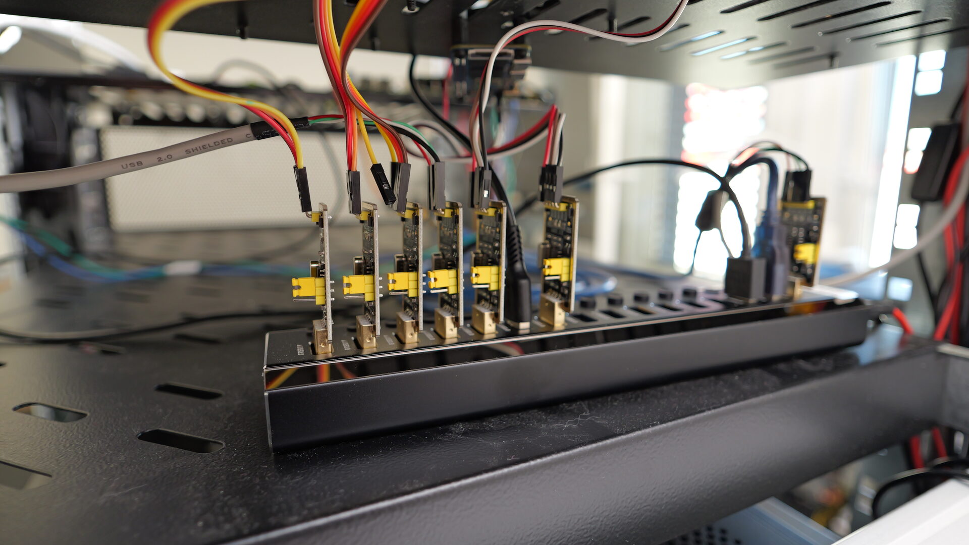 Bank of USB serial-console adapters on a powered hub